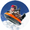 boy up in the air on a tube sledding in the snow7